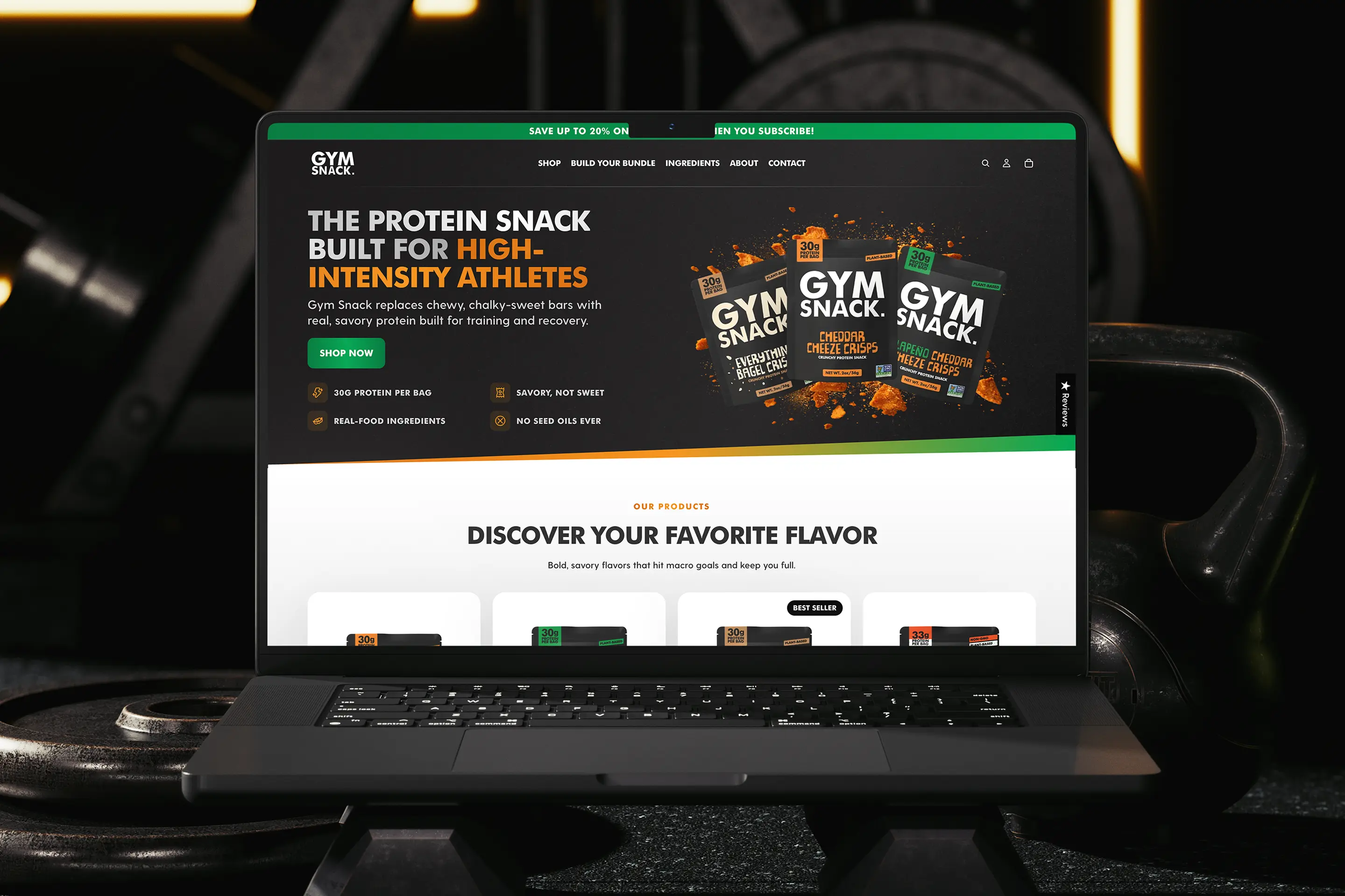 Gym Snack Shopify website displayed on a laptop in a gym setting.